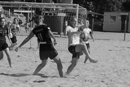 ODESSA, UKRAINE July 8, 2021: Ukrainian Beach Soccer Women's Cup. The girl's footballers are desperately playing beach soccer on sand of sea city beach on a hot sunny day. Women's soccer on sandのeditorial素材