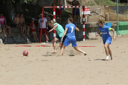 ODESSA, UKRAINE July 8, 2021: Ukrainian Beach Soccer Women's Cup. The girl's footballers are desperately playing beach soccer on sand of sea city beach on a hot sunny day. Women's soccer on sandのeditorial素材