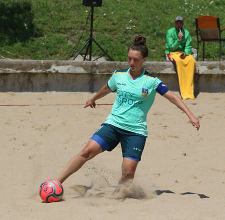 ODESSA, UKRAINE July 8, 2021: Ukrainian Beach Soccer Women's Cup. The girl's footballers are desperately playing beach soccer on sand of sea city beach on a hot sunny day. Women's soccer on sandのeditorial素材