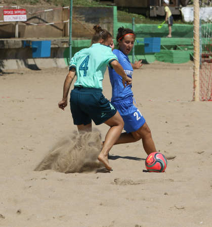 ODESSA, UKRAINE July 8, 2021: Ukrainian Beach Soccer Women's Cup. The girl's footballers are desperately playing beach soccer on sand of sea city beach on a hot sunny day. Women's soccer on sandのeditorial素材