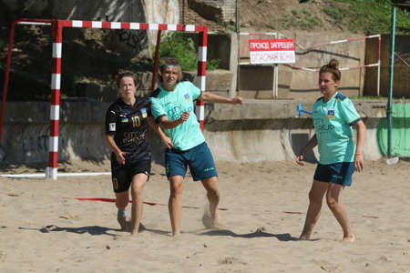 ODESSA, UKRAINE July 8, 2021: Ukrainian Beach Soccer Women's Cup. The girl's footballers are desperately playing beach soccer on sand of sea city beach on a hot sunny day. Women's soccer on sandのeditorial素材