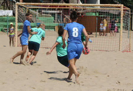 ODESSA, UKRAINE July 8, 2021: Ukrainian Beach Soccer Women's Cup. The girl's footballers are desperately playing beach soccer on sand of sea city beach on a hot sunny day. Women's soccer on sandのeditorial素材