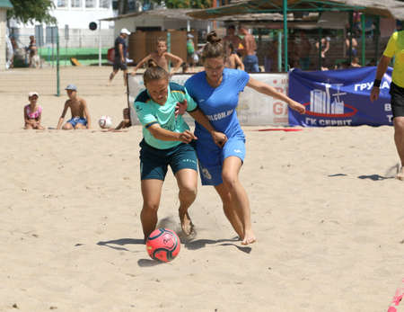 ODESSA, UKRAINE July 8, 2021: Ukrainian Beach Soccer Women's Cup. The girl's footballers are desperately playing beach soccer on sand of sea city beach on a hot sunny day. Women's soccer on sandのeditorial素材