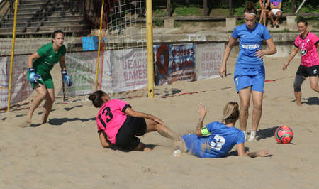 ODESSA, UKRAINE July 8, 2021: Ukrainian Beach Soccer Women's Cup. The girl's footballers are desperately playing beach soccer on sand of sea city beach on a hot sunny day. Women's soccer on sandのeditorial素材