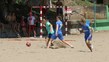 ODESSA, UKRAINE July 8, 2021: Ukrainian Beach Soccer Women's Cup. The girl's footballers are desperately playing beach soccer on sand of sea city beach on a hot sunny day. Women's soccer on sandのeditorial素材