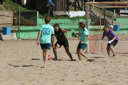 ODESSA, UKRAINE July 8, 2021: Ukrainian Beach Soccer Women's Cup. The girl's footballers are desperately playing beach soccer on sand of sea city beach on a hot sunny day. Women's soccer on sandのeditorial素材