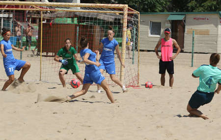 ODESSA, UKRAINE July 8, 2021: Ukrainian Beach Soccer Women's Cup. The girl's footballers are desperately playing beach soccer on sand of sea city beach on a hot sunny day. Women's soccer on sandのeditorial素材
