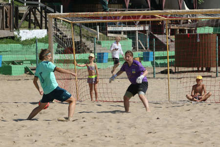 ODESSA, UKRAINE July 8, 2021: Ukrainian Beach Soccer Women's Cup. The girl's footballers are desperately playing beach soccer on sand of sea city beach on a hot sunny day. Women's soccer on sandのeditorial素材