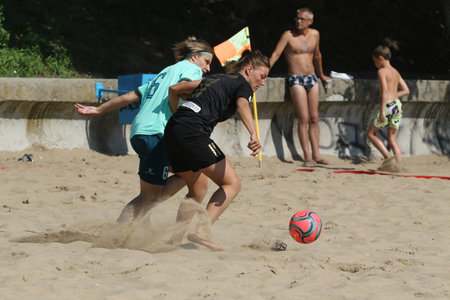 ODESSA, UKRAINE July 8, 2021: Ukrainian Beach Soccer Women's Cup. The girl's footballers are desperately playing beach soccer on sand of sea city beach on a hot sunny day. Women's soccer on sandのeditorial素材