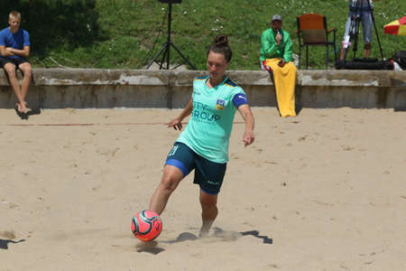 ODESSA, UKRAINE July 8, 2021: Ukrainian Beach Soccer Women's Cup. The girl's footballers are desperately playing beach soccer on sand of sea city beach on a hot sunny day. Women's soccer on sandのeditorial素材