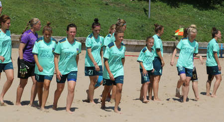 ODESSA, UKRAINE July 8, 2021: Ukrainian Beach Soccer Women's Cup. The girl's footballers are desperately playing beach soccer on sand of sea city beach on a hot sunny day. Women's soccer on sandのeditorial素材