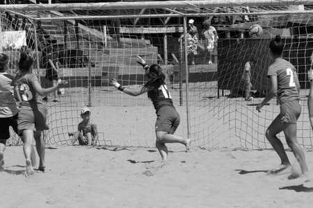 ODESSA, UKRAINE July 8, 2021: Ukrainian Beach Soccer Women's Cup. The girl's footballers are desperately playing beach soccer on sand of sea city beach on a hot sunny day. Women's soccer on sandのeditorial素材