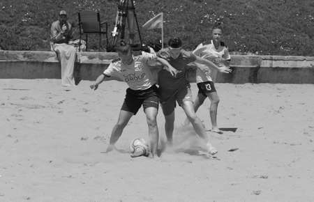 ODESSA, UKRAINE July 8, 2021: Ukrainian Beach Soccer Women's Cup. The girl's footballers are desperately playing beach soccer on sand of sea city beach on a hot sunny day. Women's soccer on sandのeditorial素材