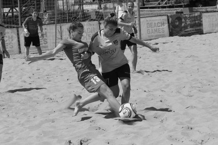 ODESSA, UKRAINE July 8, 2021: Ukrainian Beach Soccer Women's Cup. The girl's footballers are desperately playing beach soccer on sand of sea city beach on a hot sunny day. Women's soccer on sandのeditorial素材