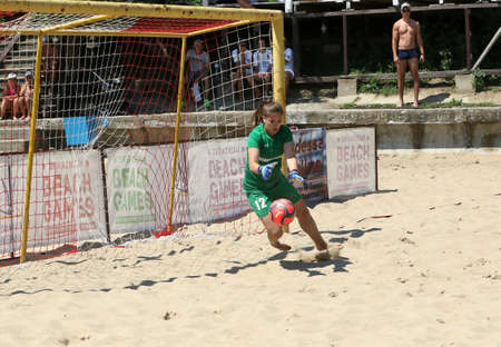ODESSA, UKRAINE July 8, 2021: Ukrainian Beach Soccer Women's Cup. The girl's footballers are desperately playing beach soccer on sand of sea city beach on a hot sunny day. Women's soccer on sandのeditorial素材