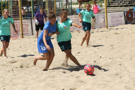 ODESSA, UKRAINE July 8, 2021: Ukrainian Beach Soccer Women's Cup. The girl's footballers are desperately playing beach soccer on sand of sea city beach on a hot sunny day. Women's soccer on sandのeditorial素材