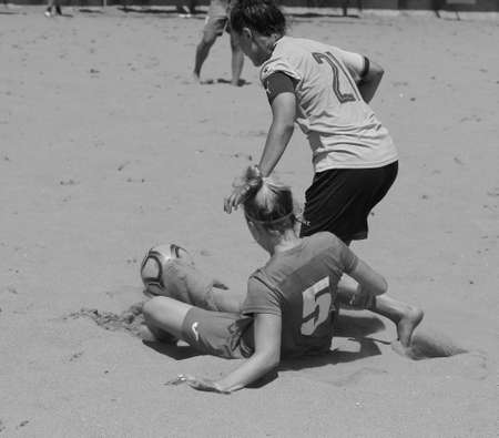 ODESSA, UKRAINE July 8, 2021: Ukrainian Beach Soccer Women's Cup. The girl's footballers are desperately playing beach soccer on sand of sea city beach on a hot sunny day. Women's soccer on sandのeditorial素材
