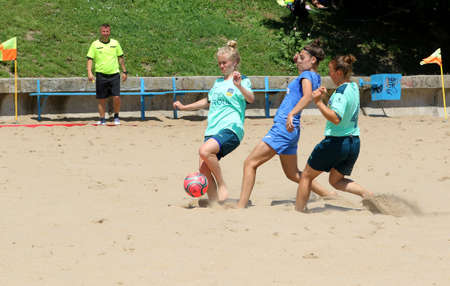ODESSA, UKRAINE July 8, 2021: Ukrainian Beach Soccer Women's Cup. The girl's footballers are desperately playing beach soccer on sand of sea city beach on a hot sunny day. Women's soccer on sandのeditorial素材
