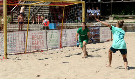 ODESSA, UKRAINE July 8, 2021: Ukrainian Beach Soccer Women's Cup. The girl's footballers are desperately playing beach soccer on sand of sea city beach on a hot sunny day. Women's soccer on sandのeditorial素材