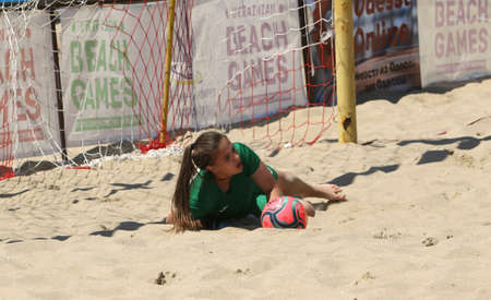 ODESSA, UKRAINE July 8, 2021: Ukrainian Beach Soccer Women's Cup. The girl's footballers are desperately playing beach soccer on sand of sea city beach on a hot sunny day. Women's soccer on sandのeditorial素材