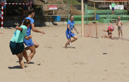 ODESSA, UKRAINE July 8, 2021: Ukrainian Beach Soccer Women's Cup. The girl's footballers are desperately playing beach soccer on sand of sea city beach on a hot sunny day. Women's soccer on sandのeditorial素材