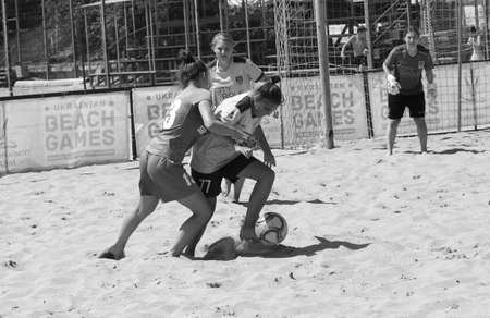 ODESSA, UKRAINE July 8, 2021: Ukrainian Beach Soccer Women's Cup. The girl's footballers are desperately playing beach soccer on sand of sea city beach on a hot sunny day. Women's soccer on sandのeditorial素材
