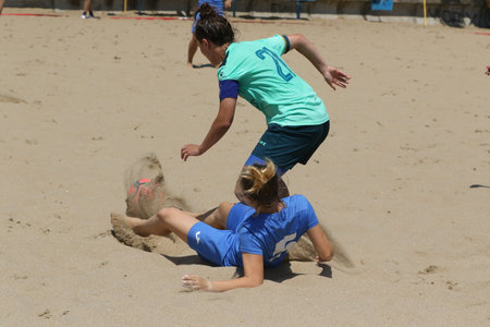 ODESSA, UKRAINE July 8, 2021: Ukrainian Beach Soccer Women's Cup. The girl's footballers are desperately playing beach soccer on sand of sea city beach on a hot sunny day. Women's soccer on sandのeditorial素材
