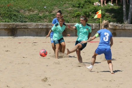 ODESSA, UKRAINE July 8, 2021: Ukrainian Beach Soccer Women's Cup. The girl's footballers are desperately playing beach soccer on sand of sea city beach on a hot sunny day. Women's soccer on sandのeditorial素材