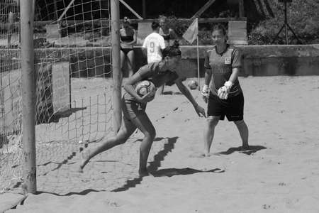 ODESSA, UKRAINE July 8, 2021: Ukrainian Beach Soccer Women's Cup. The girl's footballers are desperately playing beach soccer on sand of sea city beach on a hot sunny day. Women's soccer on sandのeditorial素材