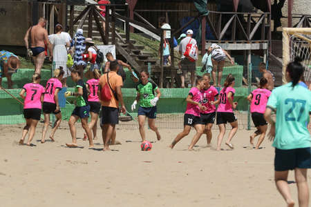 ODESSA, UKRAINE July 8, 2021: Ukrainian Beach Soccer Women's Cup. The girl's footballers are desperately playing beach soccer on sand of sea city beach on a hot sunny day. Women's soccer on sandのeditorial素材