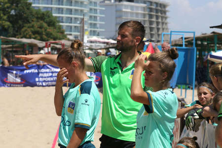 ODESSA, UKRAINE July 8, 2021: Ukrainian Beach Soccer Women's Cup. The girl's footballers are desperately playing beach soccer on sand of sea city beach on a hot sunny day. Women's soccer on sandのeditorial素材