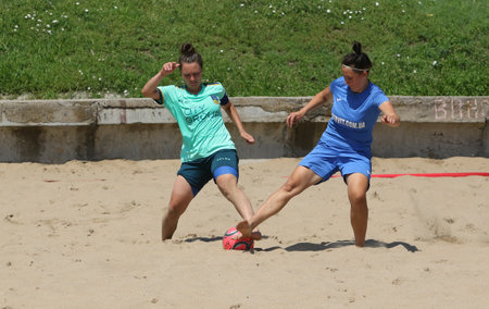 ODESSA, UKRAINE July 8, 2021: Ukrainian Beach Soccer Women's Cup. The girl's footballers are desperately playing beach soccer on sand of sea city beach on a hot sunny day. Women's soccer on sandのeditorial素材