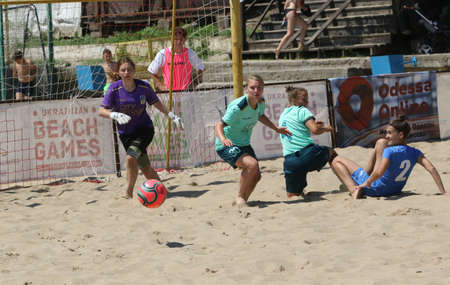 ODESSA, UKRAINE July 8, 2021: Ukrainian Beach Soccer Women's Cup. The girl's footballers are desperately playing beach soccer on sand of sea city beach on a hot sunny day. Women's soccer on sandのeditorial素材