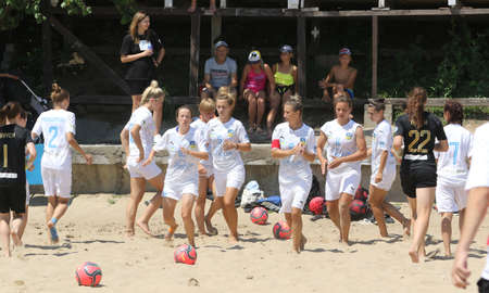 ODESSA, UKRAINE July 8, 2021: Ukrainian Beach Soccer Women's Cup. The girl's footballers are desperately playing beach soccer on sand of sea city beach on a hot sunny day. Women's soccer on sandのeditorial素材