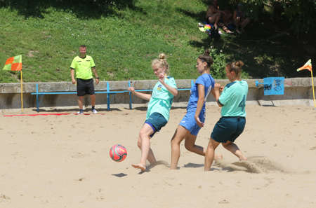 ODESSA, UKRAINE July 8, 2021: Ukrainian Beach Soccer Women's Cup. The girl's footballers are desperately playing beach soccer on sand of sea city beach on a hot sunny day. Women's soccer on sandのeditorial素材