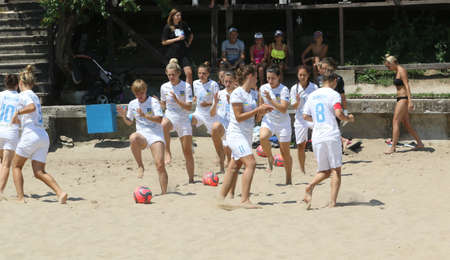 ODESSA, UKRAINE July 8, 2021: Ukrainian Beach Soccer Women's Cup. The girl's footballers are desperately playing beach soccer on sand of sea city beach on a hot sunny day. Women's soccer on sandのeditorial素材