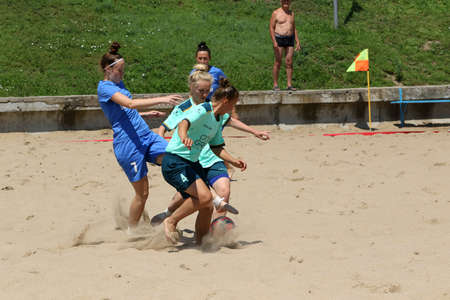 ODESSA, UKRAINE July 8, 2021: Ukrainian Beach Soccer Women's Cup. The girl's footballers are desperately playing beach soccer on sand of sea city beach on a hot sunny day. Women's soccer on sandのeditorial素材