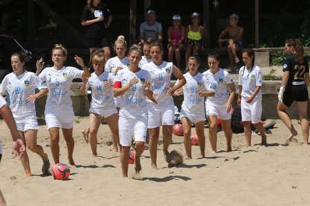 ODESSA, UKRAINE July 8, 2021: Ukrainian Beach Soccer Women's Cup. The girl's footballers are desperately playing beach soccer on sand of sea city beach on a hot sunny day. Women's soccer on sandのeditorial素材