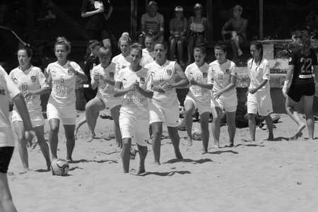 ODESSA, UKRAINE July 8, 2021: Ukrainian Beach Soccer Women's Cup. The girl's footballers are desperately playing beach soccer on sand of sea city beach on a hot sunny day. Women's soccer on sandのeditorial素材