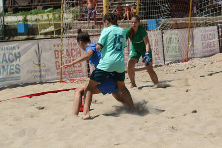ODESSA, UKRAINE July 8, 2021: Ukrainian Beach Soccer Women's Cup. The girl's footballers are desperately playing beach soccer on sand of sea city beach on a hot sunny day. Women's soccer on sandのeditorial素材