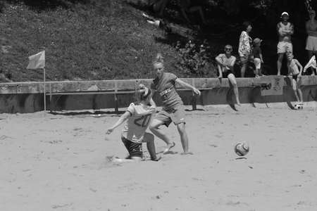 ODESSA, UKRAINE July 8, 2021: Ukrainian Beach Soccer Women's Cup. The girl's footballers are desperately playing beach soccer on sand of sea city beach on a hot sunny day. Women's soccer on sandのeditorial素材