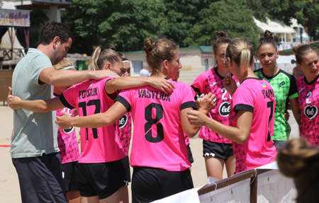ODESSA, UKRAINE July 8, 2021: Ukrainian Beach Soccer Women's Cup. The girl's footballers are desperately playing beach soccer on sand of sea city beach on a hot sunny day. Women's soccer on sandのeditorial素材