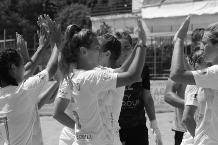 ODESSA, UKRAINE July 8, 2021: Ukrainian Beach Soccer Women's Cup. The girl's footballers are desperately playing beach soccer on sand of sea city beach on a hot sunny day. Women's soccer on sandのeditorial素材