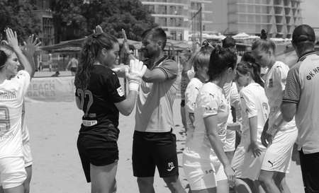 ODESSA, UKRAINE July 8, 2021: Ukrainian Beach Soccer Women's Cup. The girl's footballers are desperately playing beach soccer on sand of sea city beach on a hot sunny day. Women's soccer on sandのeditorial素材