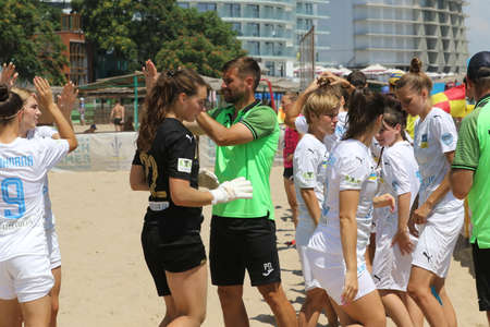 ODESSA, UKRAINE July 8, 2021: Ukrainian Beach Soccer Women's Cup. The girl's footballers are desperately playing beach soccer on sand of sea city beach on a hot sunny day. Women's soccer on sandのeditorial素材