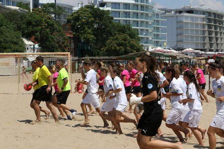 ODESSA, UKRAINE July 8, 2021: Ukrainian Beach Soccer Women's Cup. The girl's footballers are desperately playing beach soccer on sand of sea city beach on a hot sunny day. Women's soccer on sandのeditorial素材