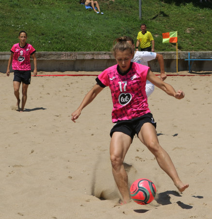 ODESSA, UKRAINE July 8, 2021: Ukrainian Beach Soccer Women's Cup. The girl's footballers are desperately playing beach soccer on sand of sea city beach on a hot sunny day. Women's soccer on sandのeditorial素材