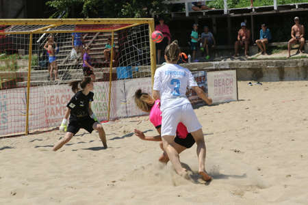 ODESSA, UKRAINE July 8, 2021: Ukrainian Beach Soccer Women's Cup. The girl's footballers are desperately playing beach soccer on sand of sea city beach on a hot sunny day. Women's soccer on sandのeditorial素材