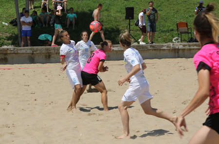 ODESSA, UKRAINE July 8, 2021: Ukrainian Beach Soccer Women's Cup. The girl's footballers are desperately playing beach soccer on sand of sea city beach on a hot sunny day. Women's soccer on sandのeditorial素材