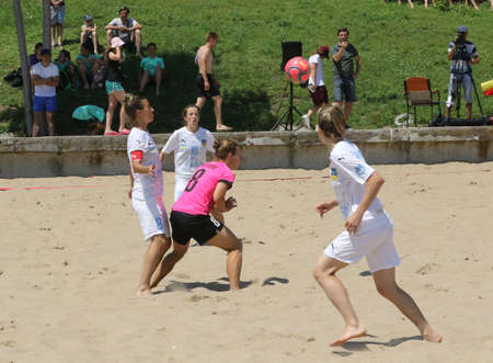 ODESSA, UKRAINE July 8, 2021: Ukrainian Beach Soccer Women's Cup. The girl's footballers are desperately playing beach soccer on sand of sea city beach on a hot sunny day. Women's soccer on sandのeditorial素材